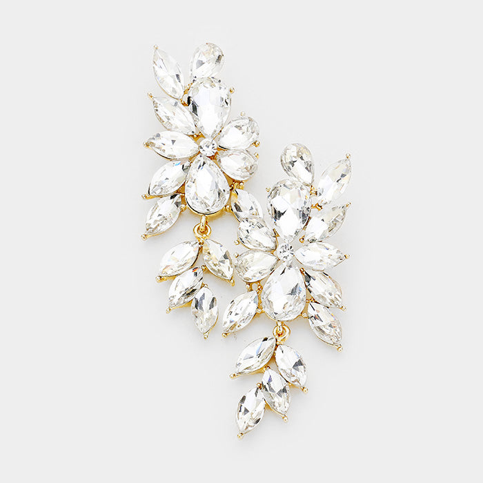 A pair of gold colored marquis shaped rhinestone dangle earrings.