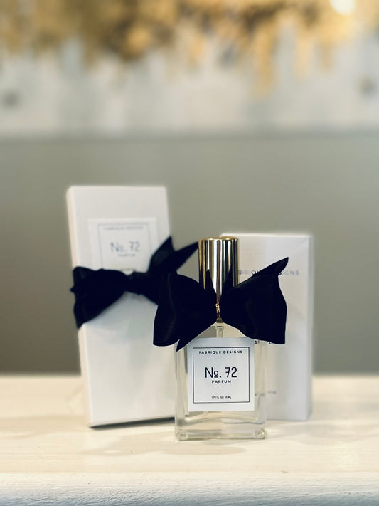 A bottle of perfume labeled 'No. 72' with a black bow on the box, indicating it is a product from the perfume brand Fabrique Parfums.