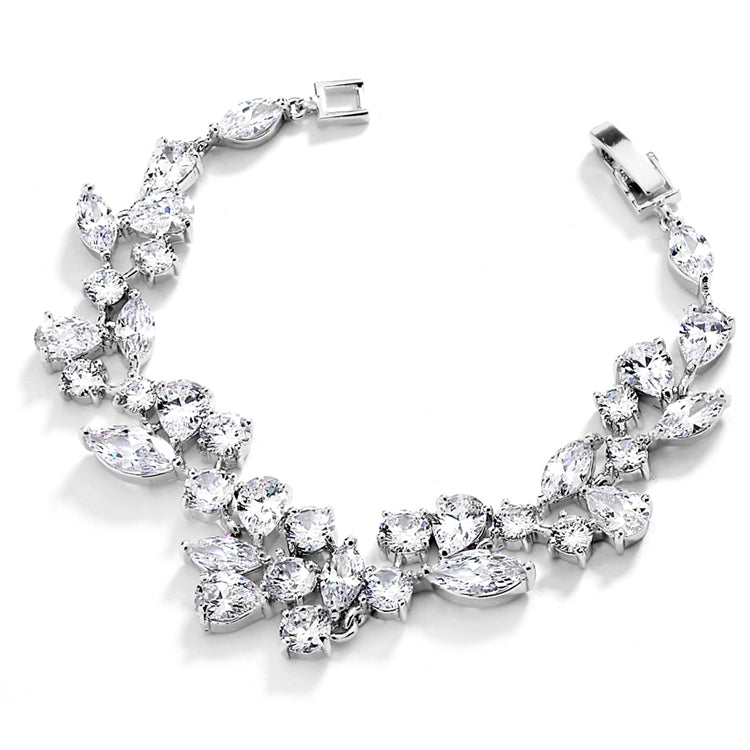 A silver-colored bridal bracelet with multiple cubic zirconia stones in different shapes such as marquise, round, and  teardrop, with a length of 7 inches.