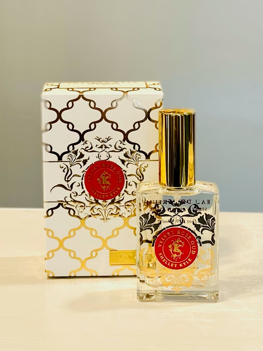 Shelley Kyle perfume in clear rectangle glass perfume bottle with gold cap and gold and red decorative box