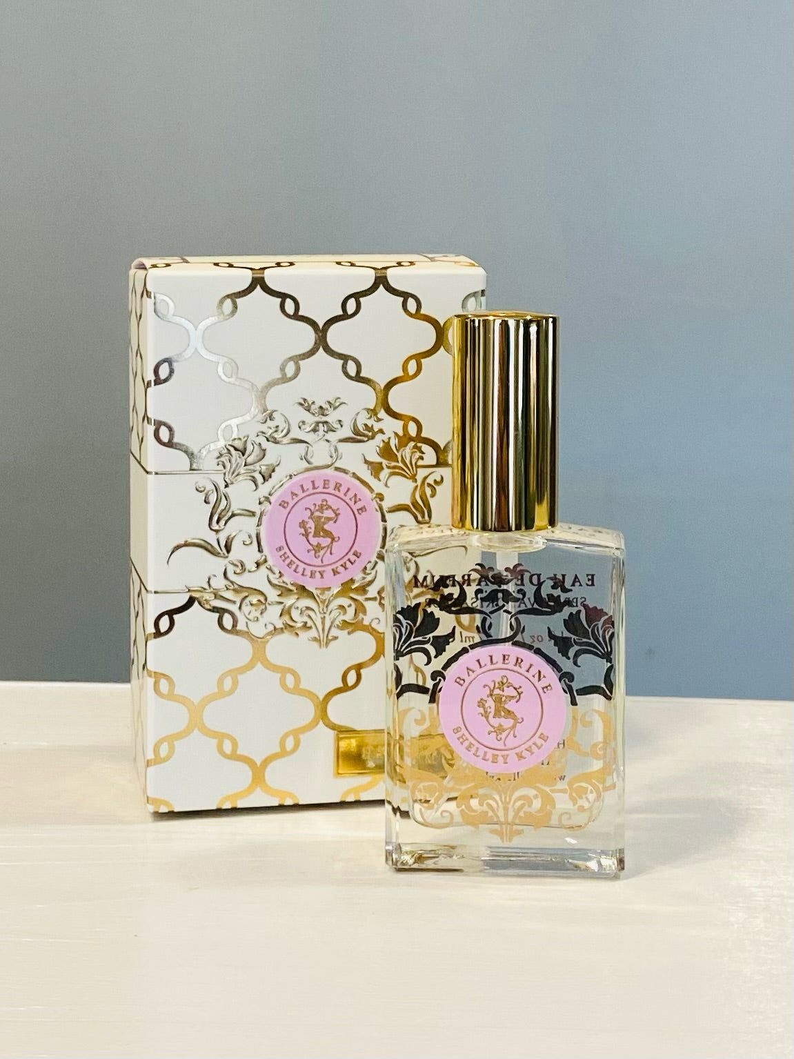Shelley Kyle Perfume, Ballerine, in a rectangle clear glass perfume bottle with gold lid and gold and pink decorative box