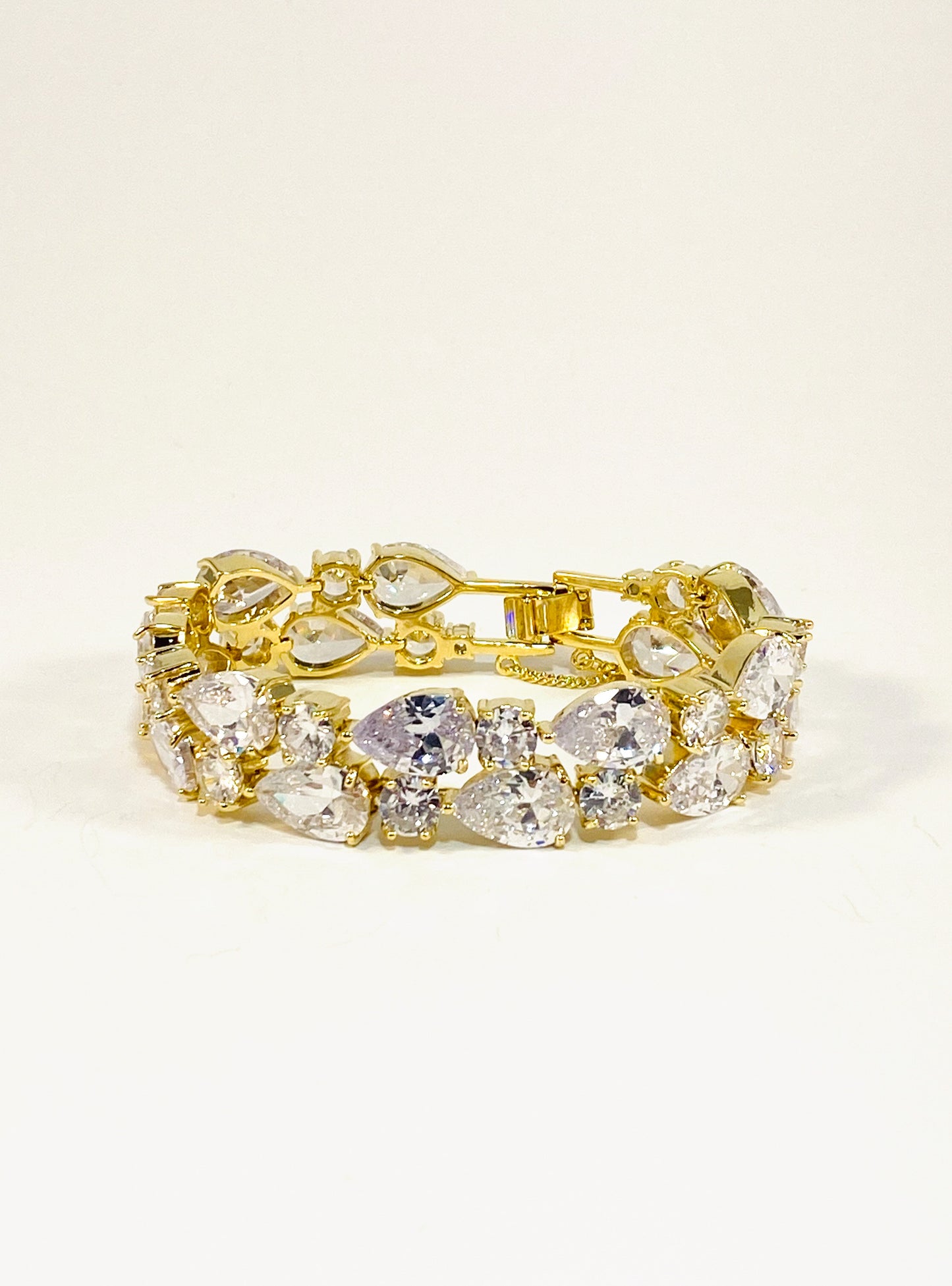 A gold-colored bridal bracelet adorned with sparkling clear cubic zirconia, designed for smaller wrists.