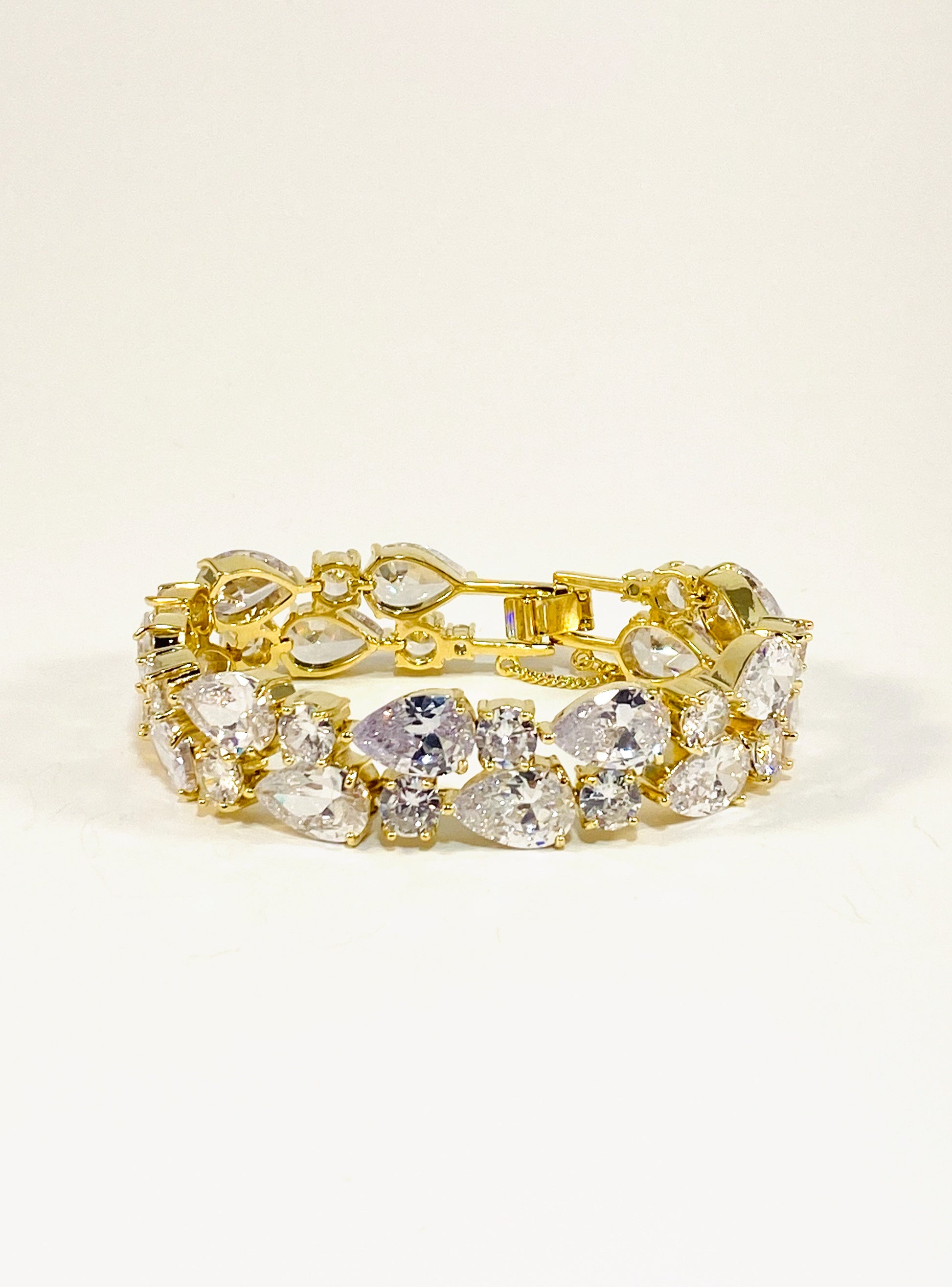 A gold-colored bridal bracelet adorned with sparkling clear cubic zirconia, designed for smaller wrists.