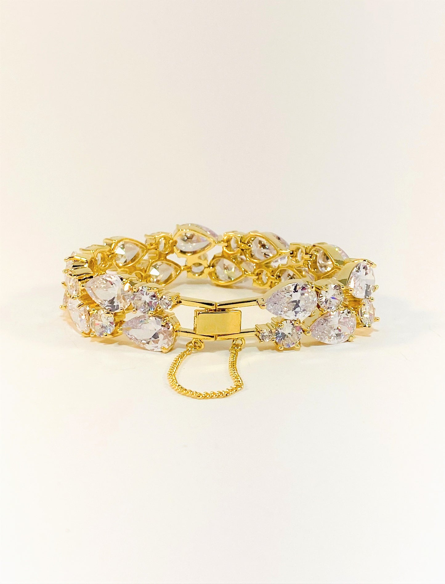A gold-colored bridal bracelet adorned with sparkling clear cubic zirconia, designed for smaller wrists.