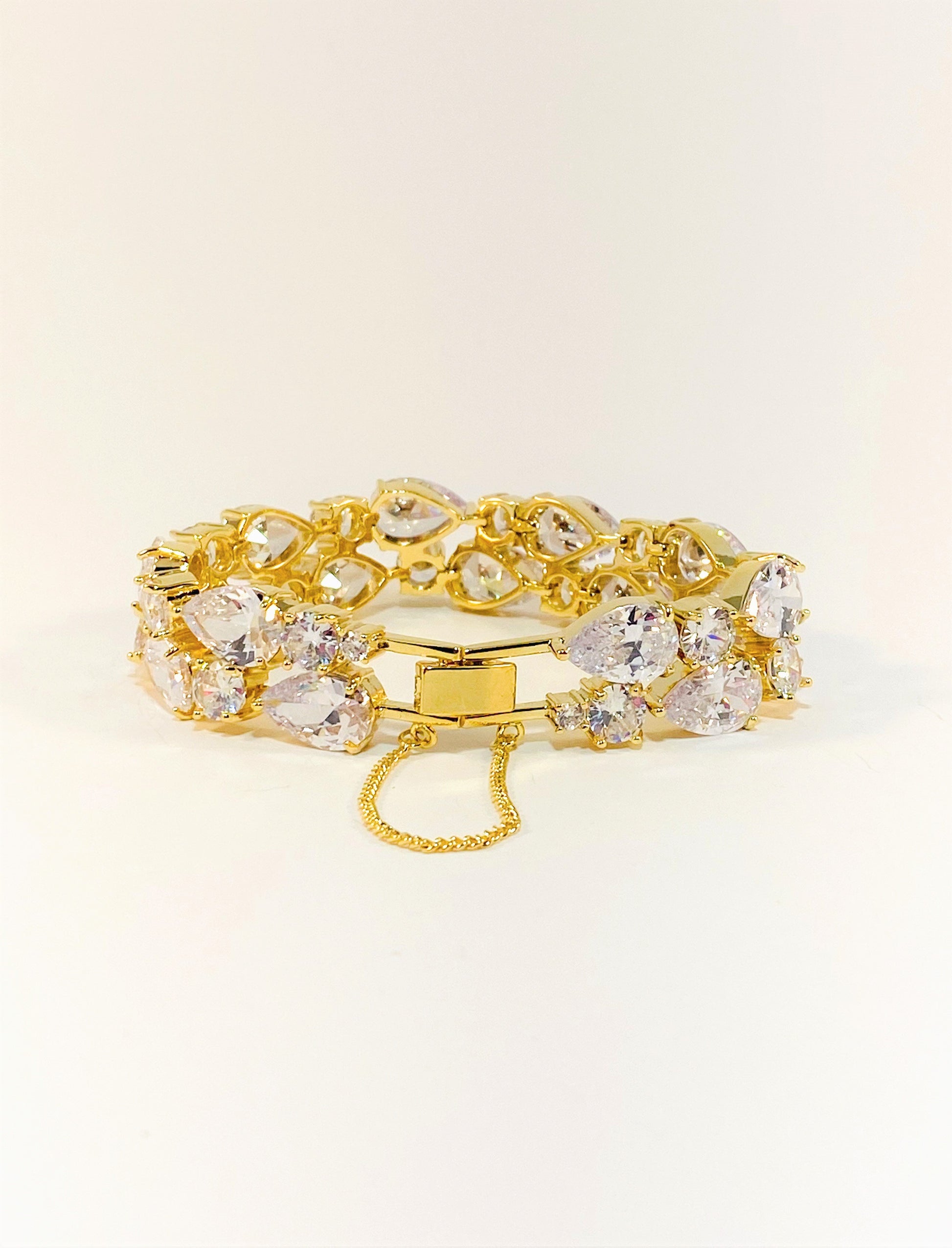 A gold-colored bridal bracelet adorned with sparkling clear cubic zirconia, designed for smaller wrists.