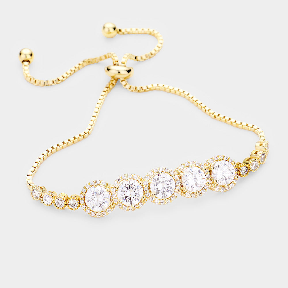 A gold-colored bridal bracelet with multiple round rhinestones and a chain-link design, intended for special occasions.