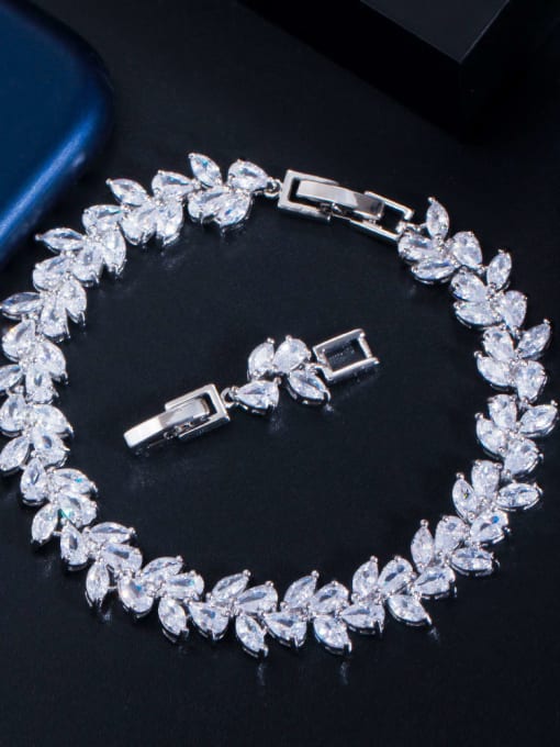 A bridal bracelet featuring a series of cascading marquis and teardrop-shaped clear crystals, with a metallic clasp.