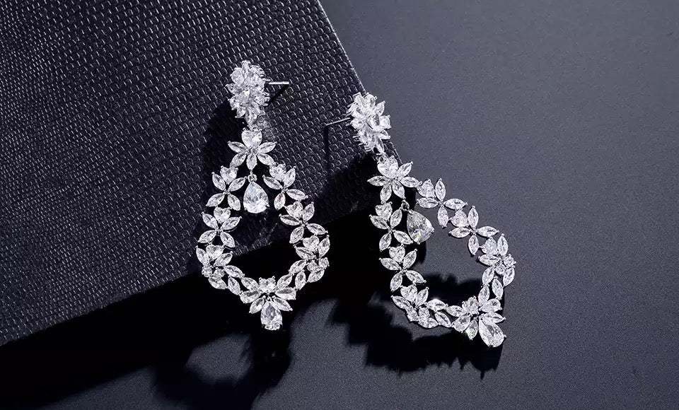 Cubic zirconia dangle earrings with marquis and teardrop stones.