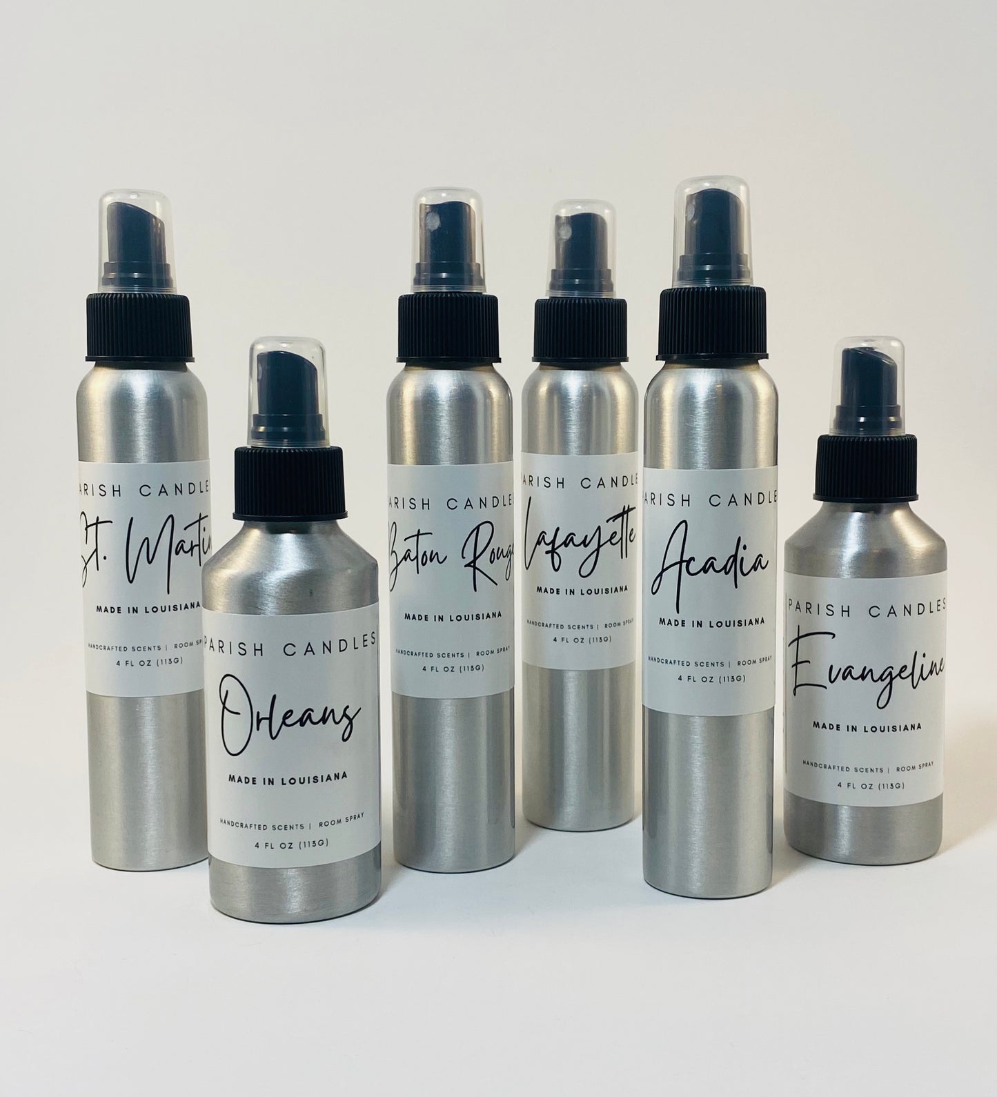 A collection of aluminum room spray bottles with fine mist sprayers, each labeled with different names such as 'Acadia', 'Baton Rouge', 'Orleans', etc.