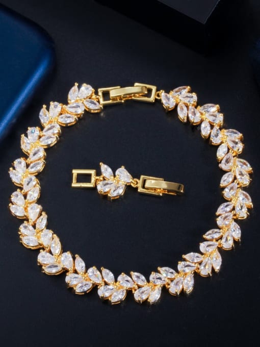 A bridal bracelet featuring a series of cascading marquis and teardrop-shaped clear crystals, with a metallic clasp in a gold color.