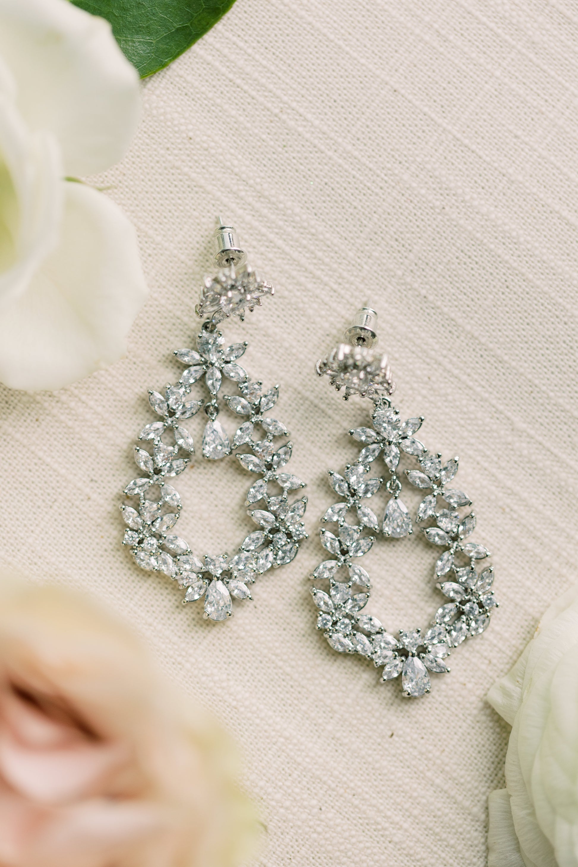 Cubic zirconia dangle earrings with marquis and teardrop stones.